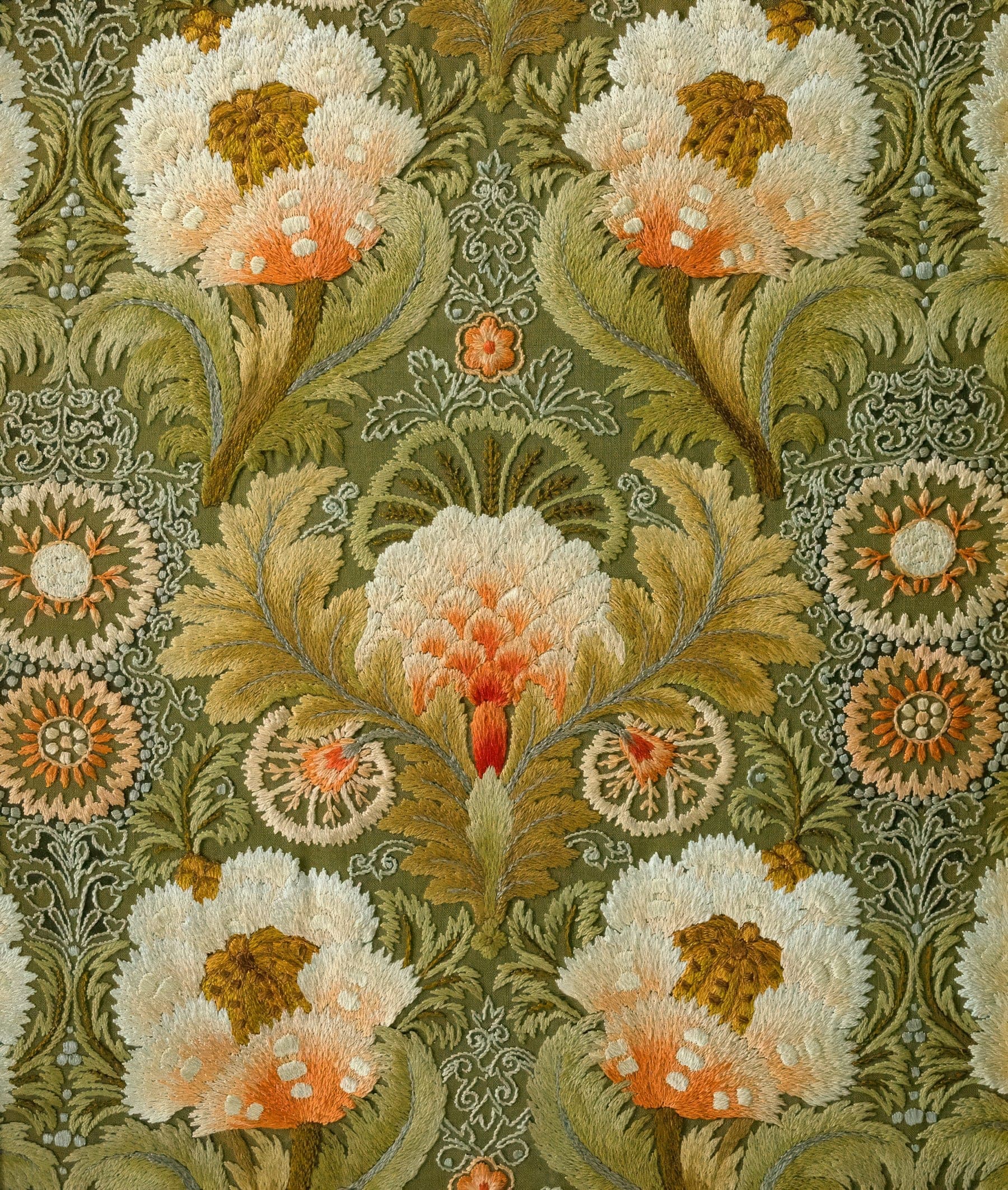 Dense floral embroidery in sage, ivory and coral thread